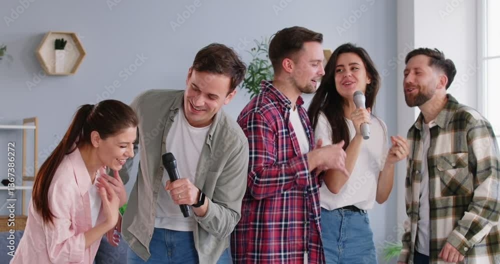 Slow motion video of happy smiling people friends in casual clothes singing in karaoke using microphone, dancing and having fun at home together. Friendship and home entertainment concept. 4k video. Slow motion video of happy smiling people friends in casual clothes singing in karaoke using microphone, dancing and having fun at home together. Friendship and home entertainment concept. 4k video.