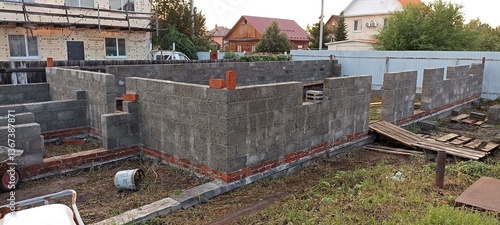 unfinished block walls standing on a brick foundation
