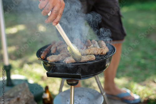 Obraz na płótnie Man preparing barbeque in the garden on a hot summer day. w salonie