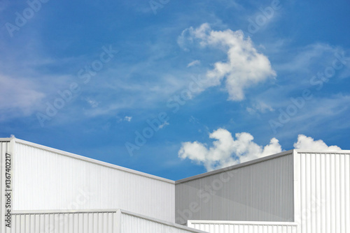 silver corrugated metal box square shape perspective view. geometric design corrugated texture line pattern abstract background against blue sky white cloud