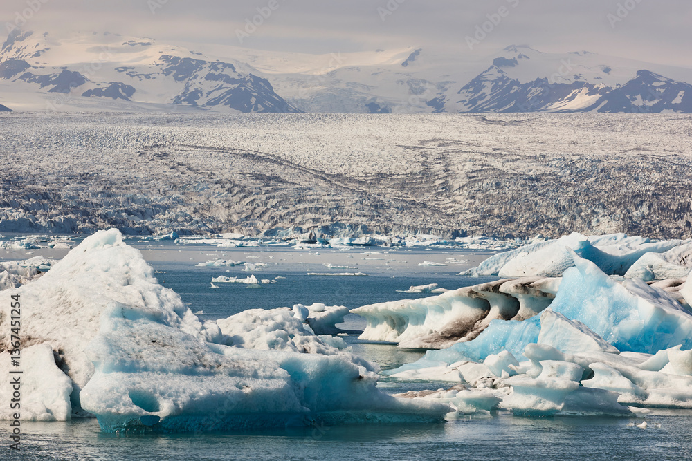 Icebergs turquoise lake and snowy mountains. Jokulsarlon, Southeast area. Iceland.