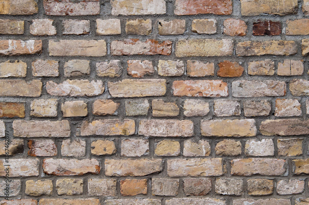 Obraz premium The photo shows a close-up of a brick wall made of old bricks