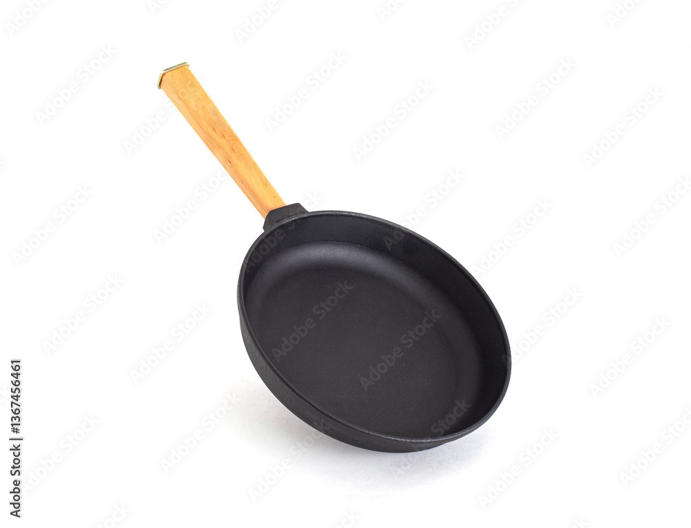 Round frying pan with non-stick coating and wooden handle on white background, isolate, close-up Round frying pan with non-stick coating and wooden handle on white background, isolate, close-up