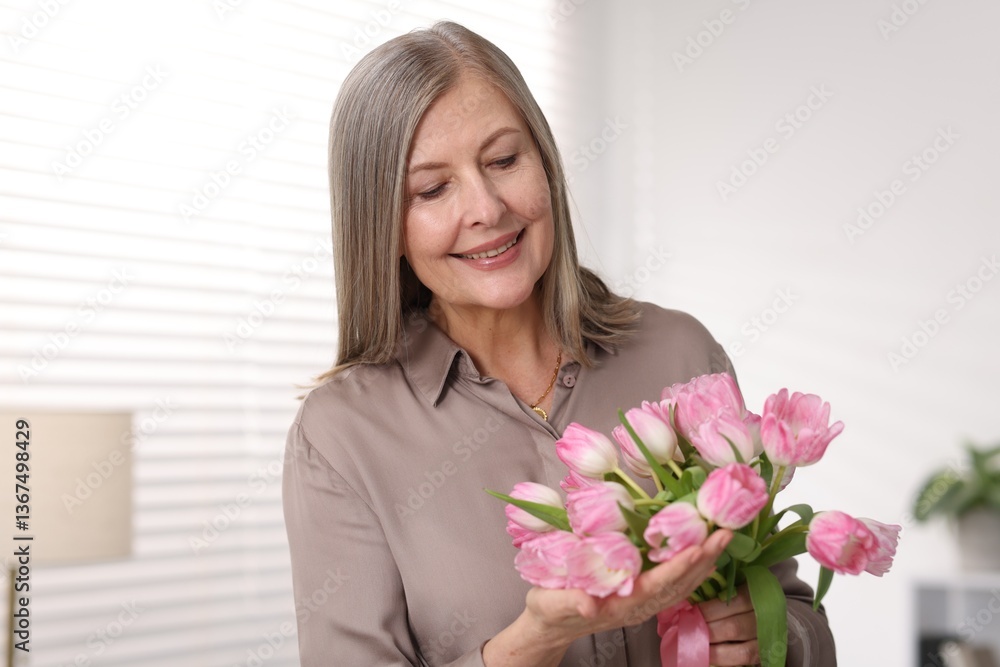 Smiling woman with bouquet of tulips at home Smiling woman with bouquet of tulips at home