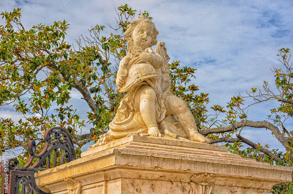 Grace in marble: A helmeted boy in the Parterre Garden of the Royal Palace of Aranjuez, Madrid, Spain Grace in marble: A helmeted boy in the Parterre Garden of the Royal Palace of Aranjuez, Madrid, Spain