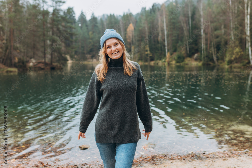Fall autumn hiker woman outdoor at nature forest and lake for camping travel. Scenery of the majestic lake. Active lifestyle. Travel concept. High quality photo