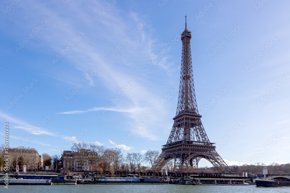 Fototapeta premium Paris, France - February 23, 2025: Eiffel Tower on the Seine River in Paris, France, early spring