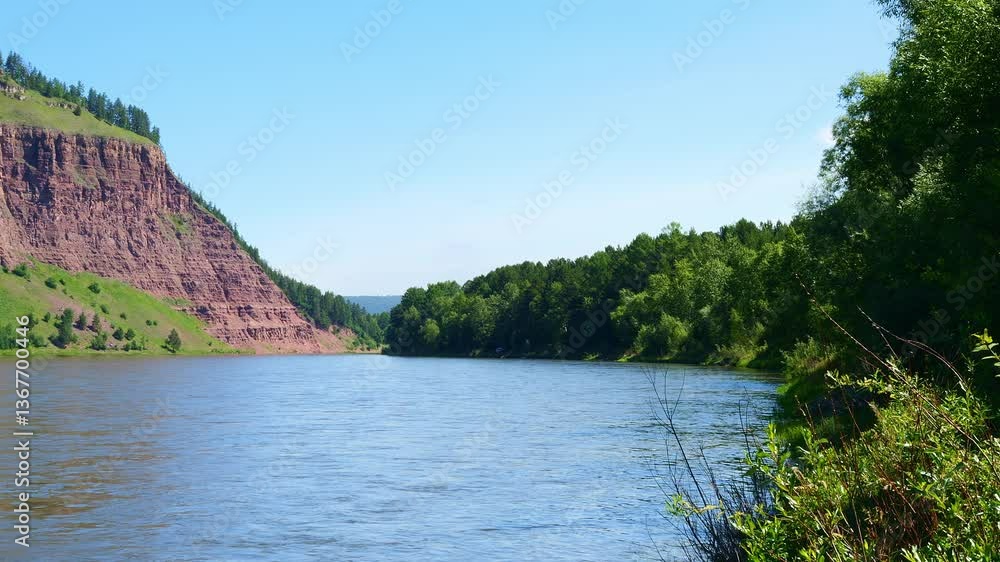 Majestic river meanders through towering rock formations and dense vegetation offering a peaceful retreat Untouched wilderness provides sense of solitude relaxation and awe Scenic nature concept Majestic river meanders through towering rock formations and dense vegetation offering a peaceful retreat Untouched wilderness provides sense of solitude relaxation and awe Scenic nature concept