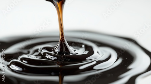 Close-up of molasses pouring and creating ripples on a smooth surface