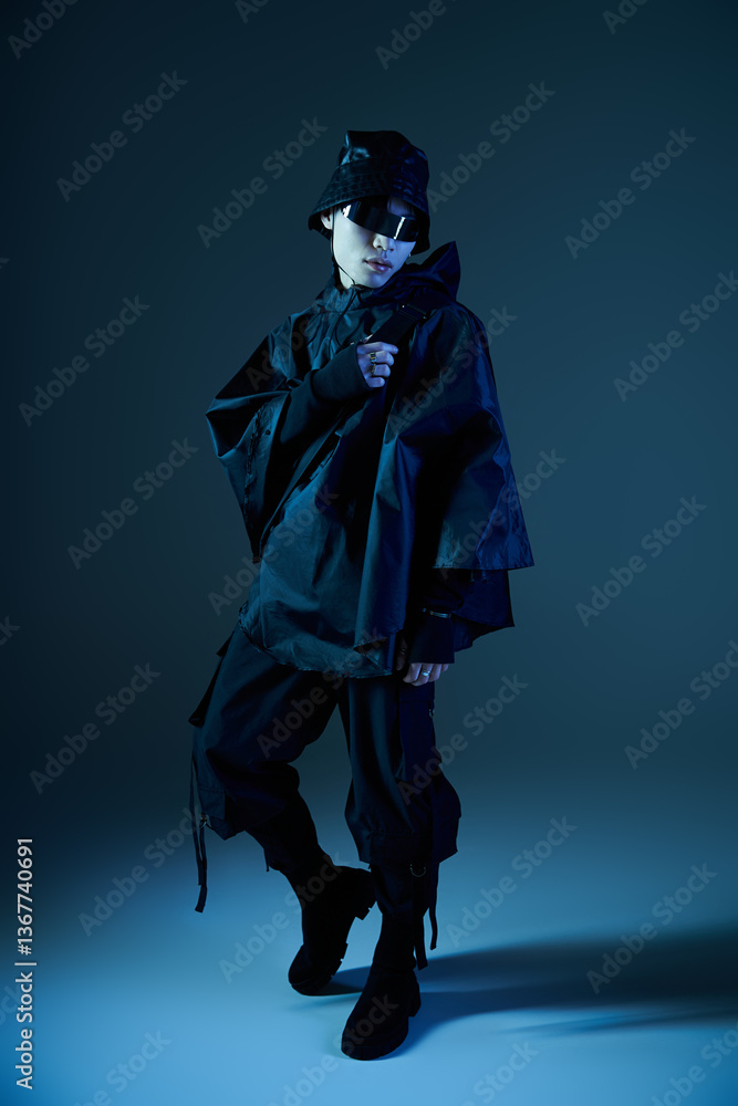 Fototapeta premium Stylish young man showcasing modern fashion in an artistic urban setting at dusk