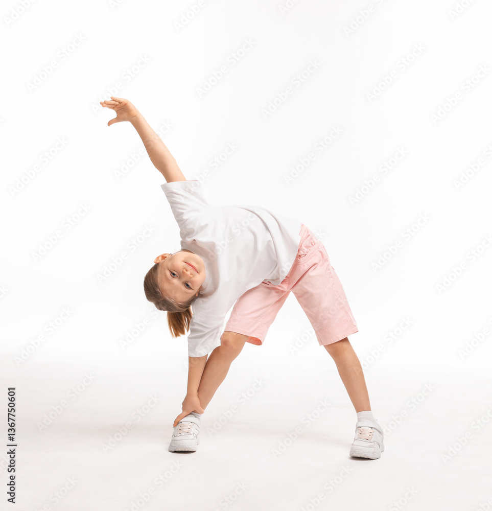 Naklejka premium Cute little girl exercising on white background