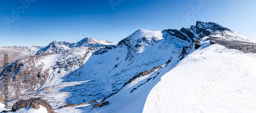 Snowy high altitude summits of the Spanish Sierra Nevada, in front of Pico de la Veleta, Mulhacen and Alcazaba, Andalusia, Granada, Spain