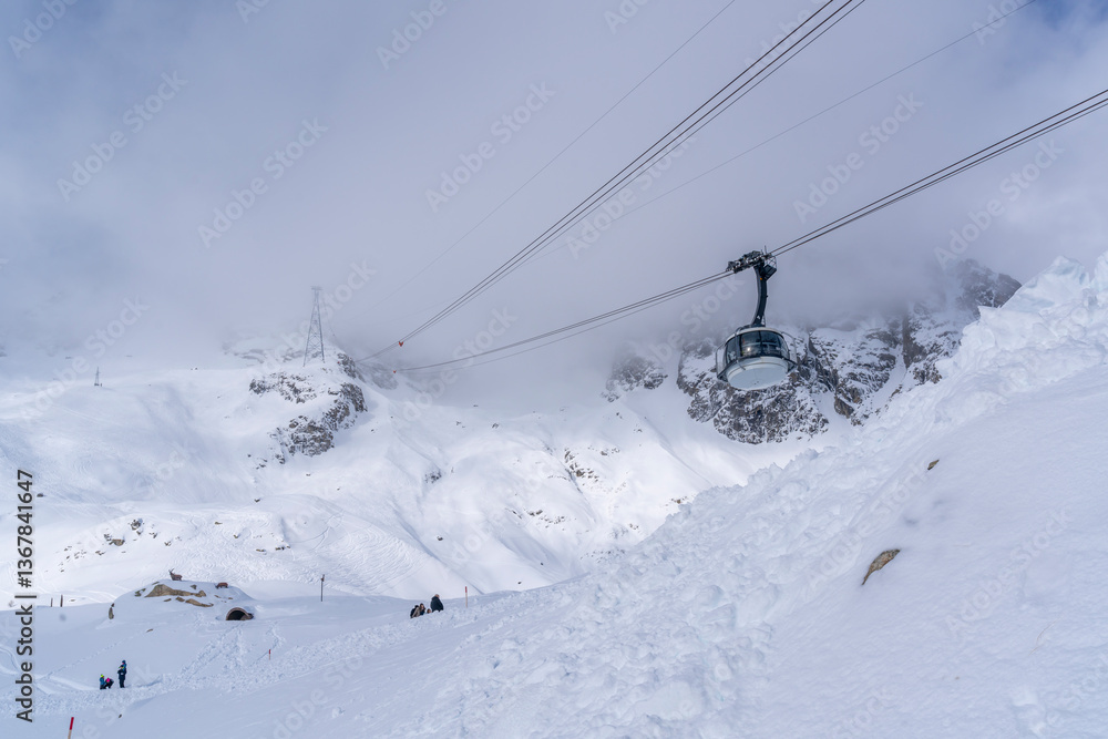 View of snow covered Aosta Valley, mountains and Skyway Monte Bianco cable car in winter, Courmayeur, Aosta Valley, Italian Alps View of snow covered Aosta Valley, mountains and Skyway Monte Bianco cable car in winter, Courmayeur, Aosta Valley, Italian Alps