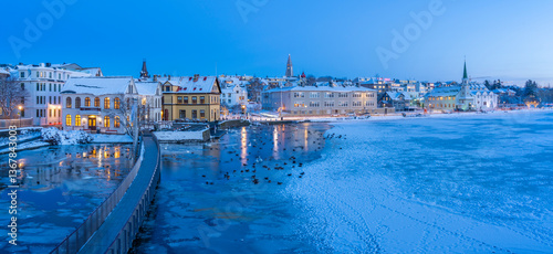 View of waterfront buildings and city skyline in background in the city centre of Reykjavik at dusk in winter, Reykjavik