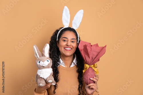 cheerful black woman with easter egg in beige colors. holiday, easter, celebration concept.