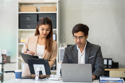 Business man and business woman working and meeting with chart at office.