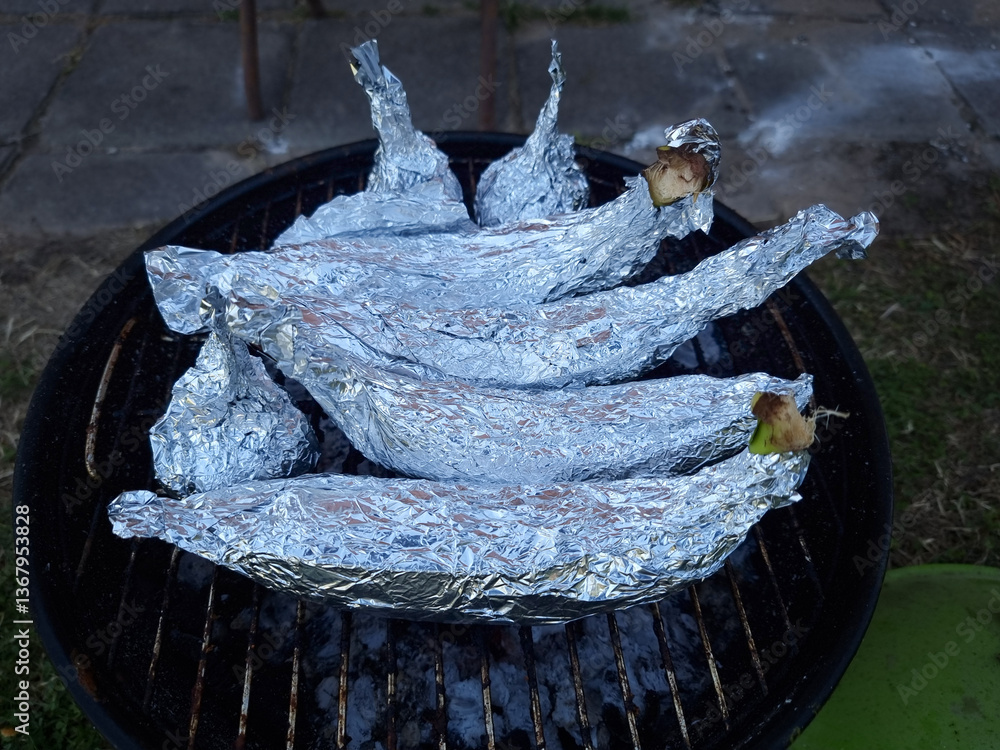 Bananas and chocolate cooked in aluminium foil. Campfire Chocolate Bananas the Ultimate Camping Dessert