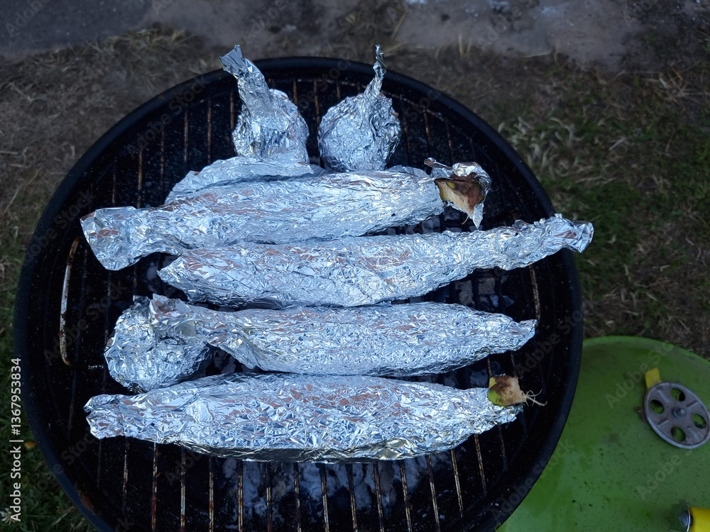 Bananas and chocolate cooked in aluminium foil. Campfire Chocolate Bananas the Ultimate Camping Dessert