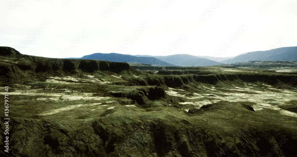 A rugged terrain features sharp cliffs and textured rock formations under a clear sky. Distant mountains provide a scenic backdrop, enhancing the natural beauty of the location. A rugged terrain features sharp cliffs and textured rock formations under a clear sky. Distant mountains provide a scenic backdrop, enhancing the natural beauty of the location.