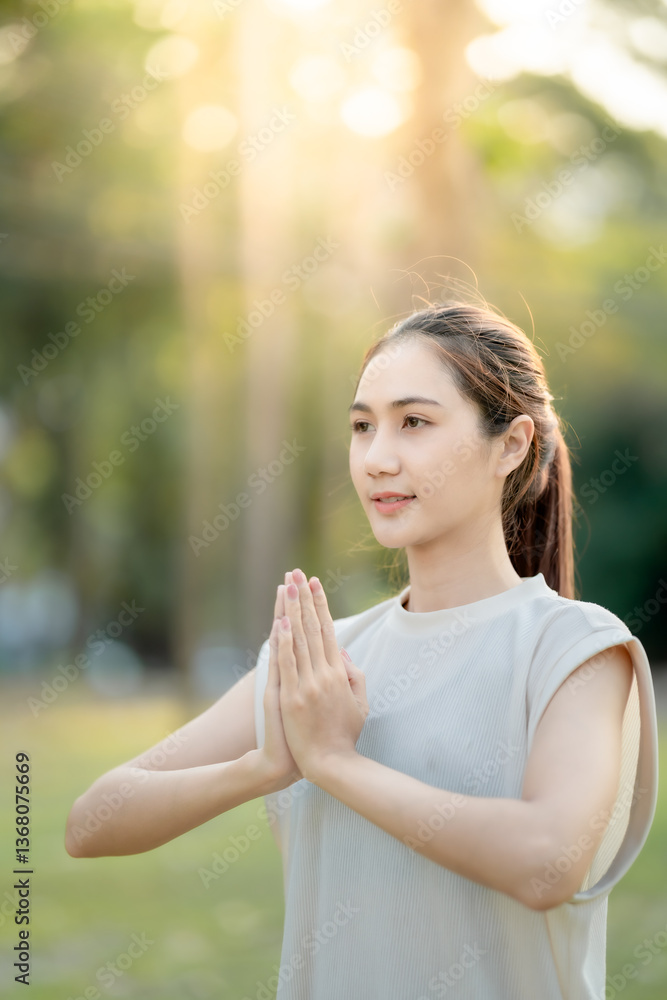 Young Asian woman doing yoga in the garden. Relaxing and healthy lifestyle concept. Young Asian woman doing yoga in the garden. Relaxing and healthy lifestyle concept.