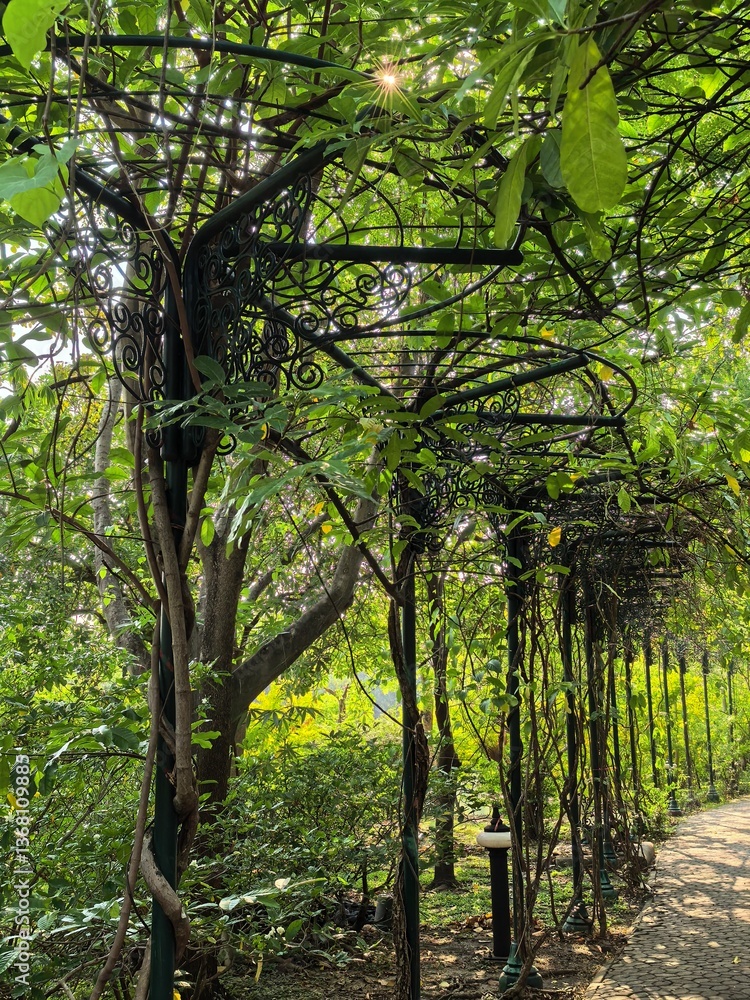 Fototapeta premium Ornate Metal Arbor in Lush Green Garden
