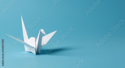 Serene white origami crane elegantly poised on blue. AI Generated