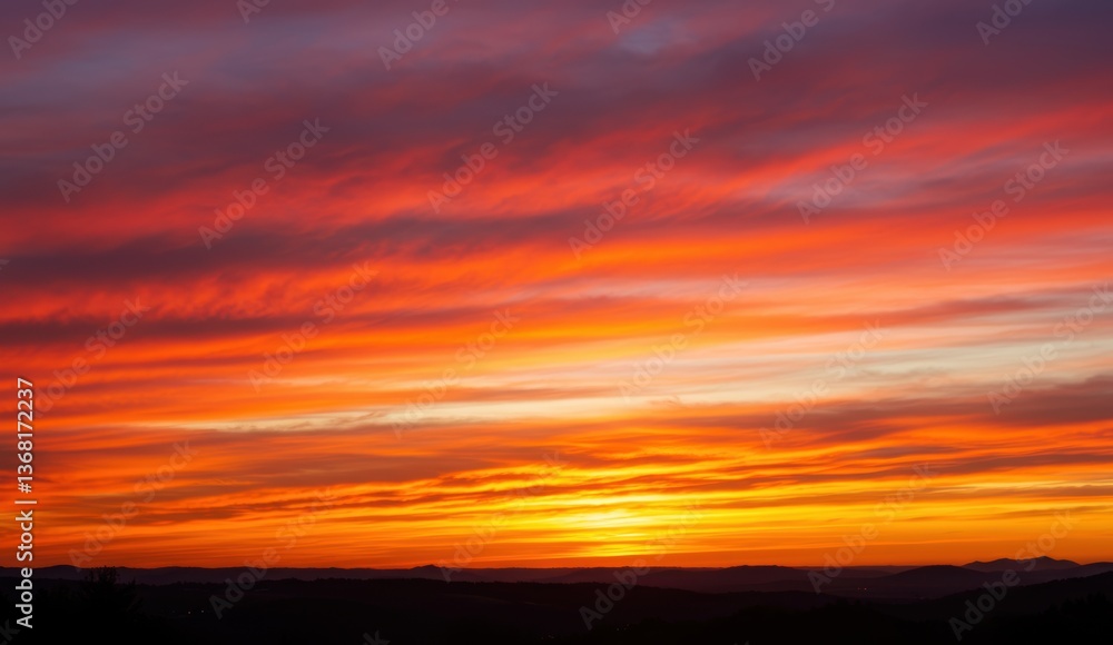 Fototapeta premium Colorful sunset over horizon with dramatic clouds, showcasing nature's beauty and peaceful outdoor atmosphere.