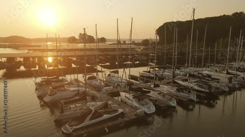 Flying drone over beautiful yachts and boats during sunrise/ sunset.