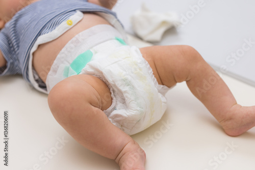 Obraz na płótnie Baby lying on soft surface wearing diaper w salonie