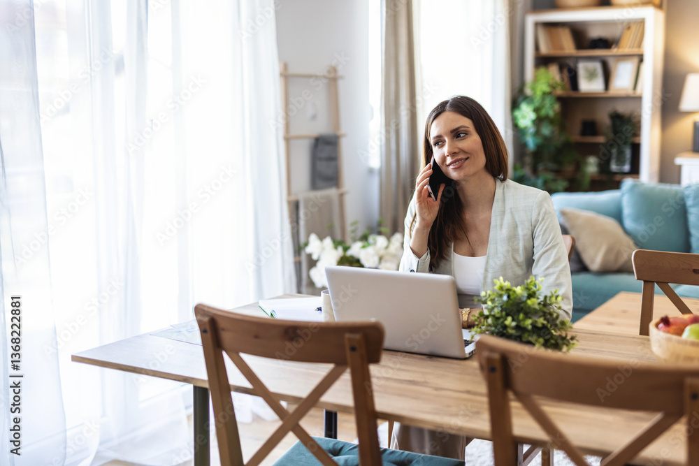 Laptop, phone call and happy woman at desk in home office for communication, schedule plan or networking. Remote work, smartphone and consultant with contact, conversation and freelance connectivity. Laptop, phone call and happy woman at desk in home office for communication, schedule plan or networking. Remote work, smartphone and consultant with contact, conversation and freelance connectivity.