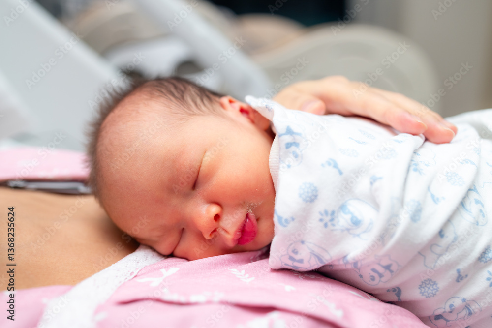 Newborn baby sleeping on mother chest.