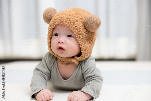 Obraz na płótnie Happy baby wearing a furry bear hat indoors w salonie