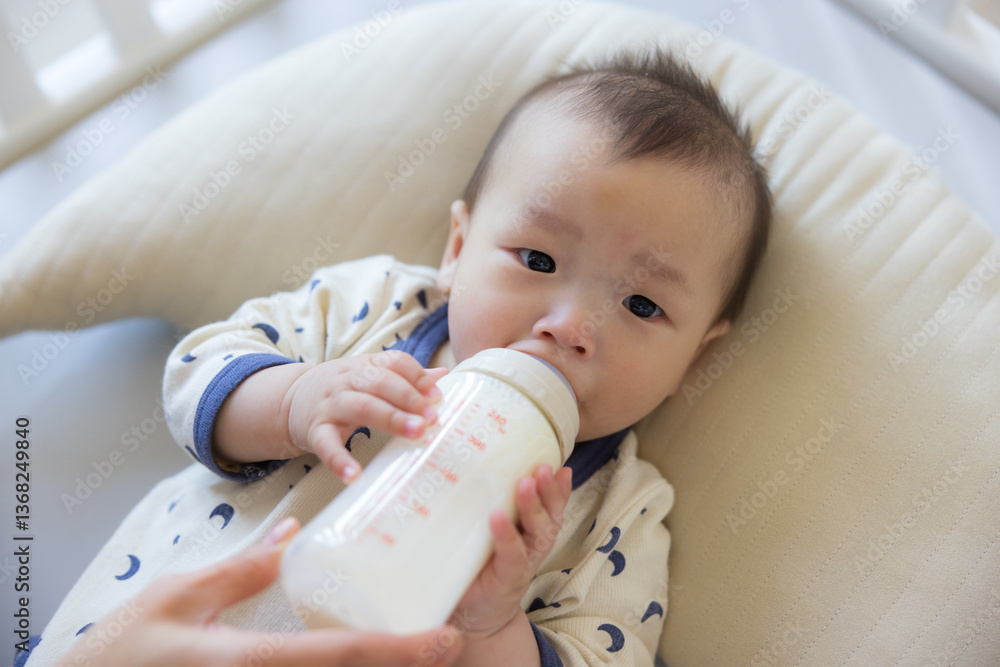 Cute baby drinking milk from bottle