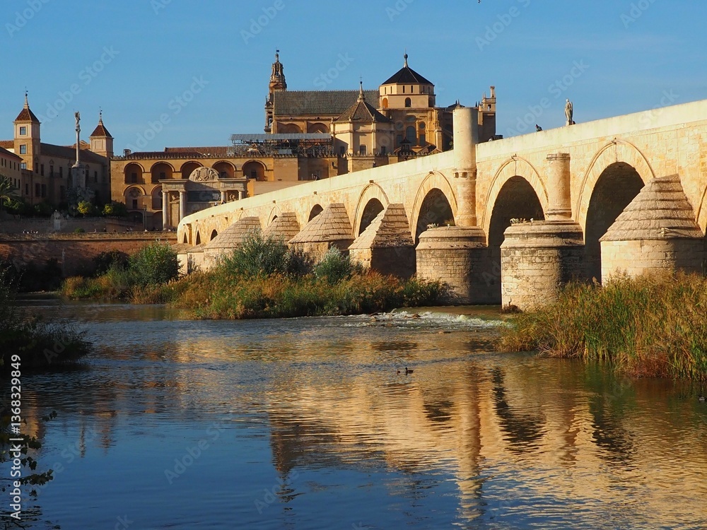 View of the Roman Bridge and Mezquita in Cordoba, Andalusia, Spain on a sunny day. View of the Roman Bridge and Mezquita in Cordoba, Andalusia, Spain on a sunny day.