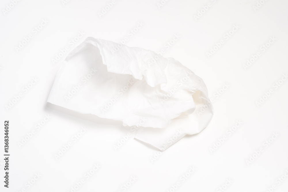 A crumpled piece of white tissue paper, isolated on a white background. Shows the delicate texture and folds of the thin material. A crumpled piece of white tissue paper, isolated on a white background. Shows the delicate texture and folds of the thin material.