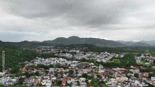 Breathtaking view of mountain landscape and residential area in cloudy weather