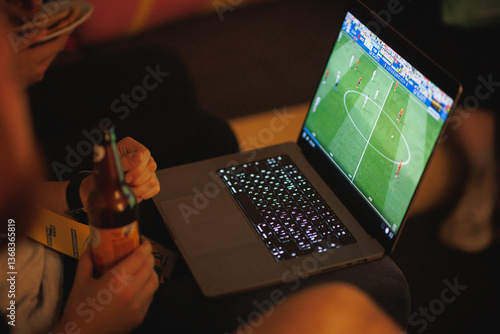 A person is currently watching an exciting soccer game on their laptop