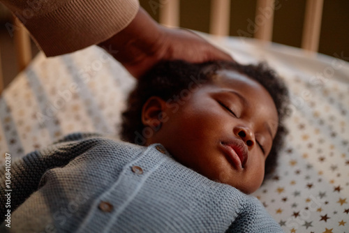 Cuadro en lienzo Close up on peaceful face of Black baby girl sleeping in crib while mothers hand