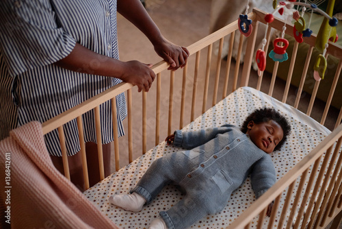 Canvas Print High angle shot of little Black child dressed in knitted jumpsuit of blue color