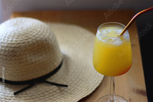 Obraz na płótnie Plate with watermelon slices, glass of orange juice or cocktail, straw hat, colorful beaded necklace and sunglasses on the wooden table. Summer essentials concept. Selective focus. w salonie