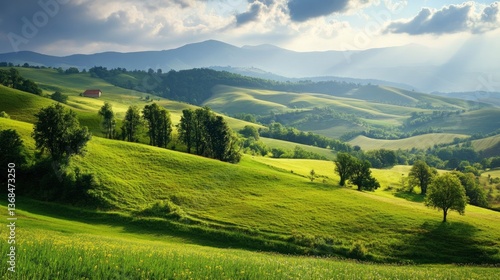 Scenic Rolling Hills Landscape with Green Fields and Distant Mountains