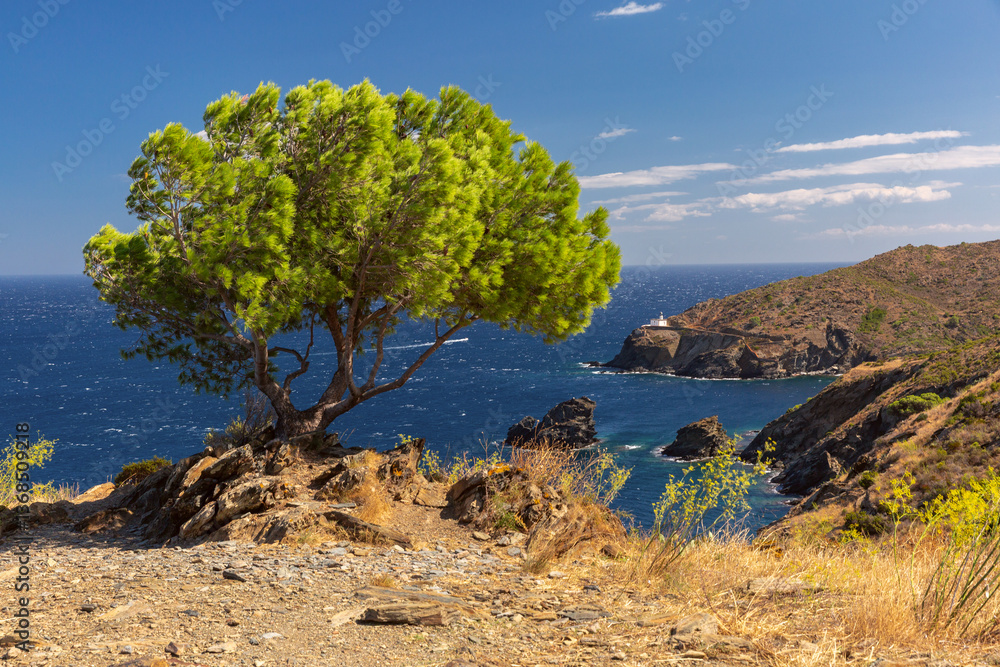 Far de Cala Nans lighthouse on rocky coastline near Cadaques in Spain