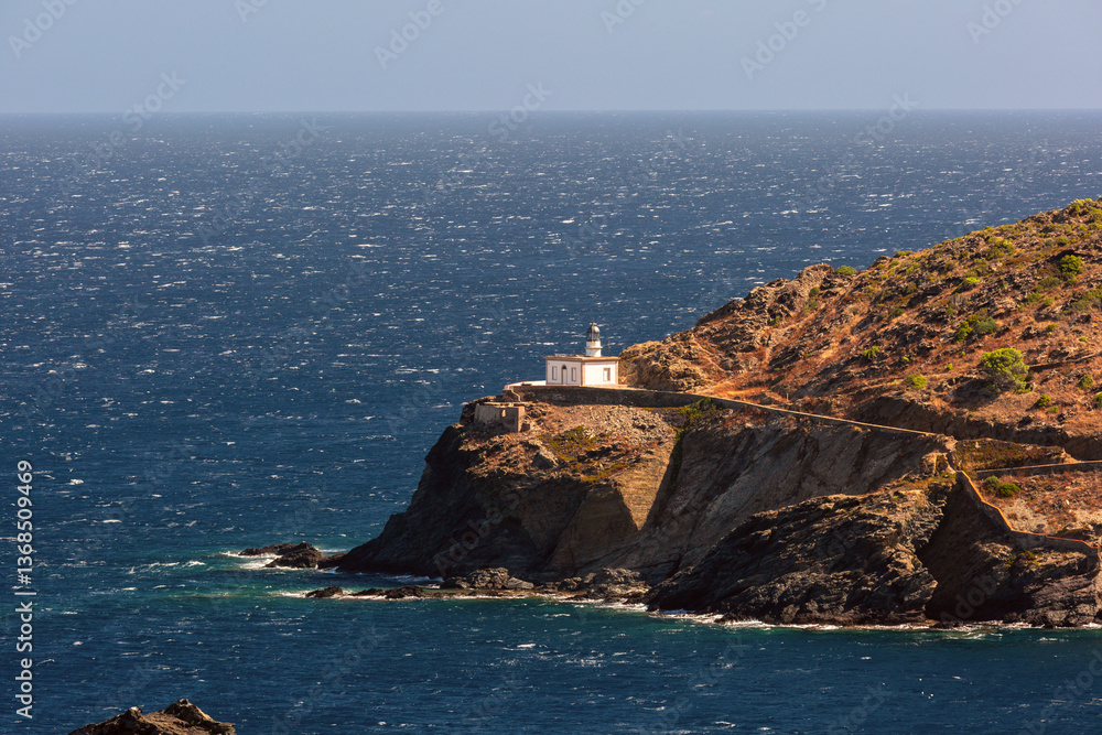 Far de Cala Nans lighthouse on rocky coastline near Cadaques in Spain