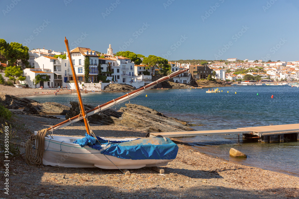 Shallow coastal water and boats facing Cadaques village in Spain