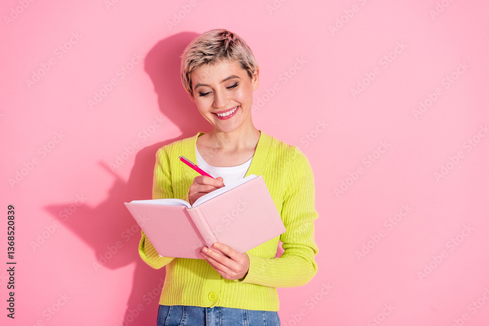 Cheerful Woman Writing in a Notebook Against a Vibrant Pink Backdrop, Concept Of Creativity and Inspiration Cheerful Woman Writing in a Notebook Against a Vibrant Pink Backdrop, Concept Of Creativity and Inspiration