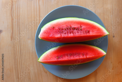 Obraz na płótnie Plate with two watermelon slices on the table. Top view. w salonie