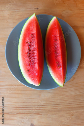 Obraz na płótnie Plate with two watermelon slices on the table. Top view. w salonie