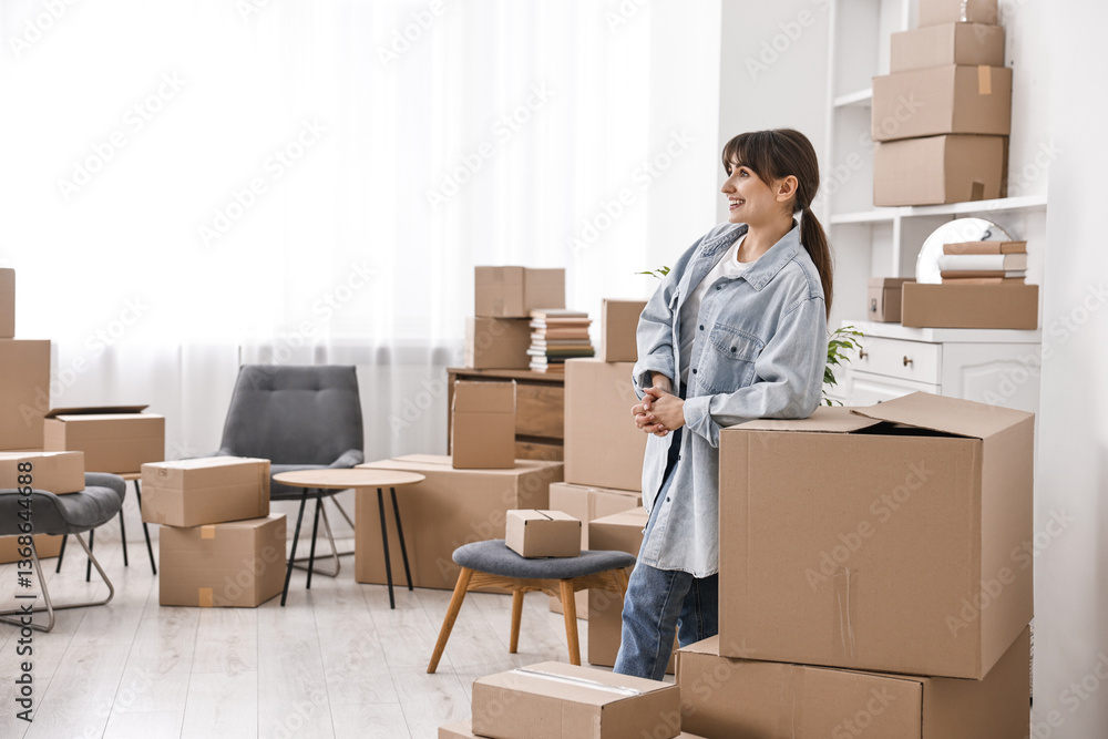 Moving day. Happy woman with her belongings in new home Moving day. Happy woman with her belongings in new home