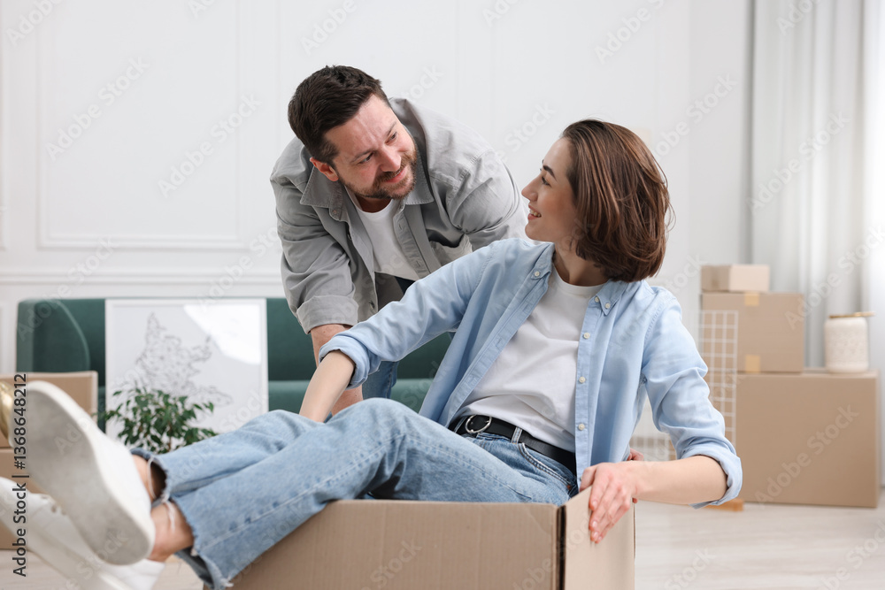Moving day. Happy couple having fun in their new home Moving day. Happy couple having fun in their new home