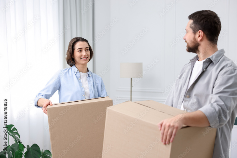 Moving day. Happy couple with cardboard boxes in their new home Moving day. Happy couple with cardboard boxes in their new home